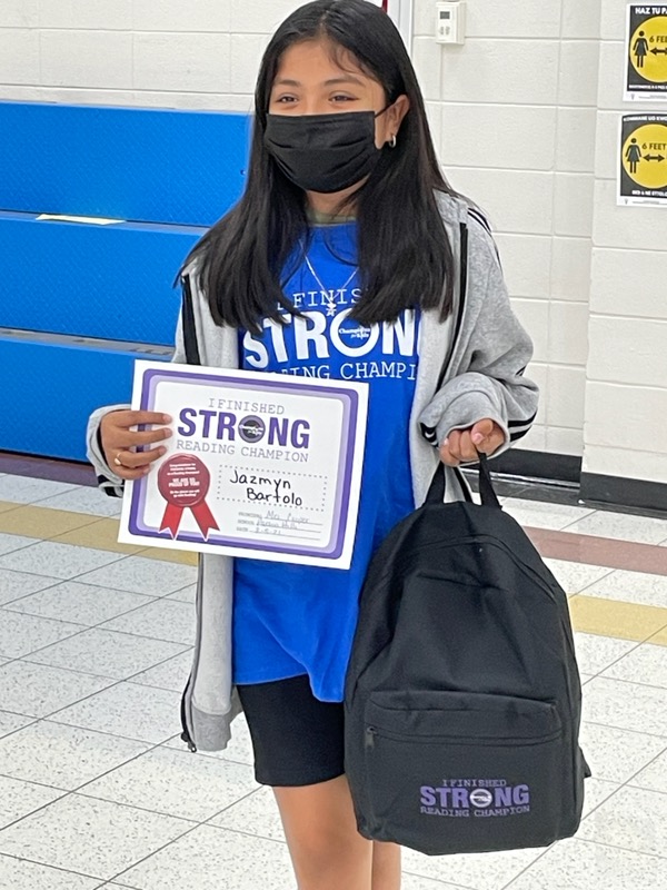 A woman holding a certificate and backpack.