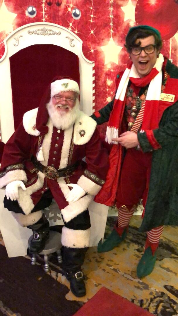 Two people dressed up as santa and elf